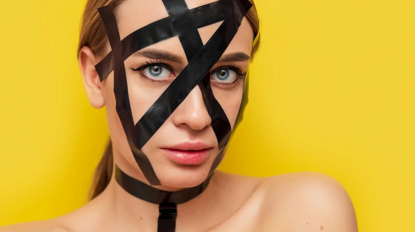 a beautiful woman with tape on her face posing