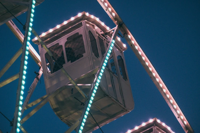 a carnival ferris wheel with lights hanging off it