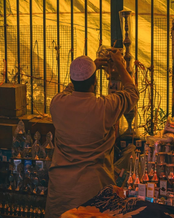 a man standing in front of a store holding a lamp