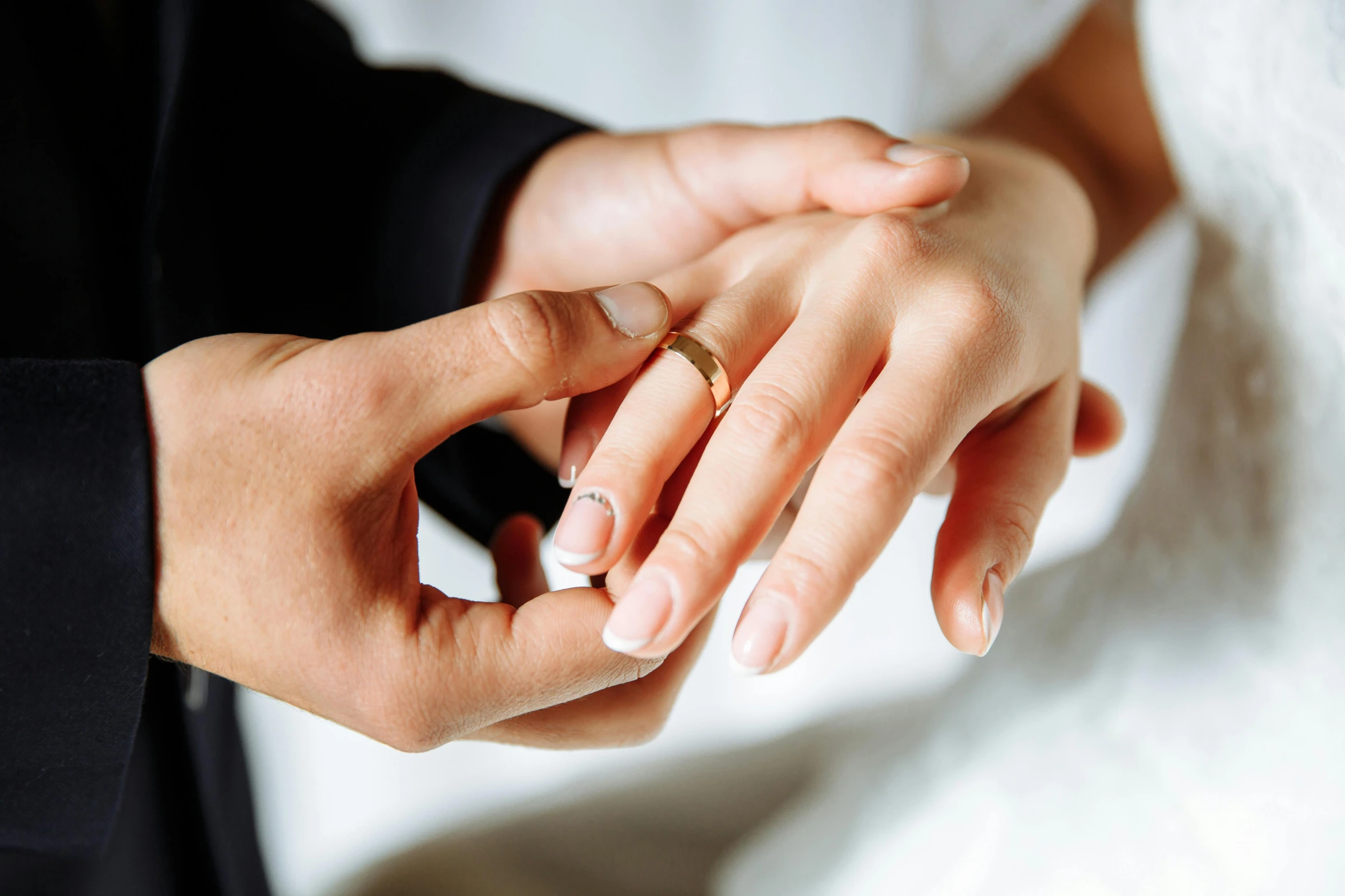 bride and groom holding hands while touching each other