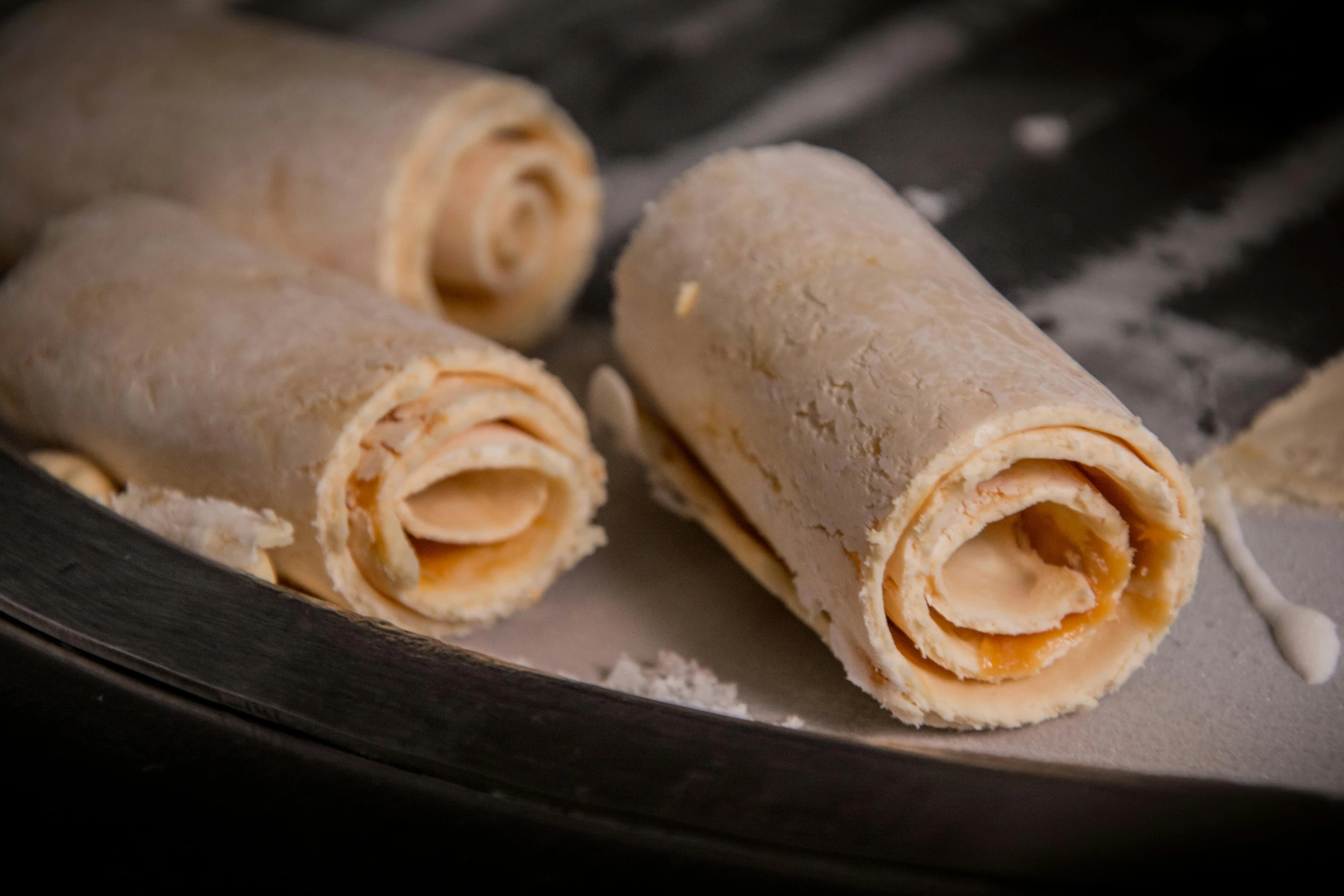 a close up of two burritos sitting on top of a pan