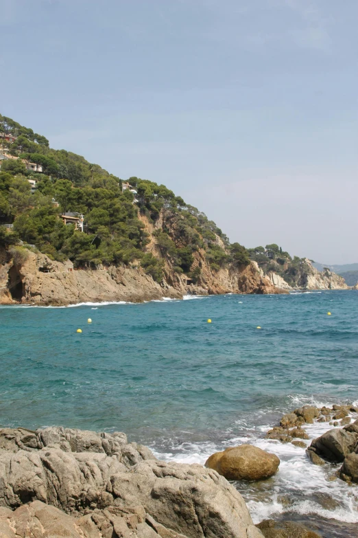 the coast is full of rocks, water and mountains