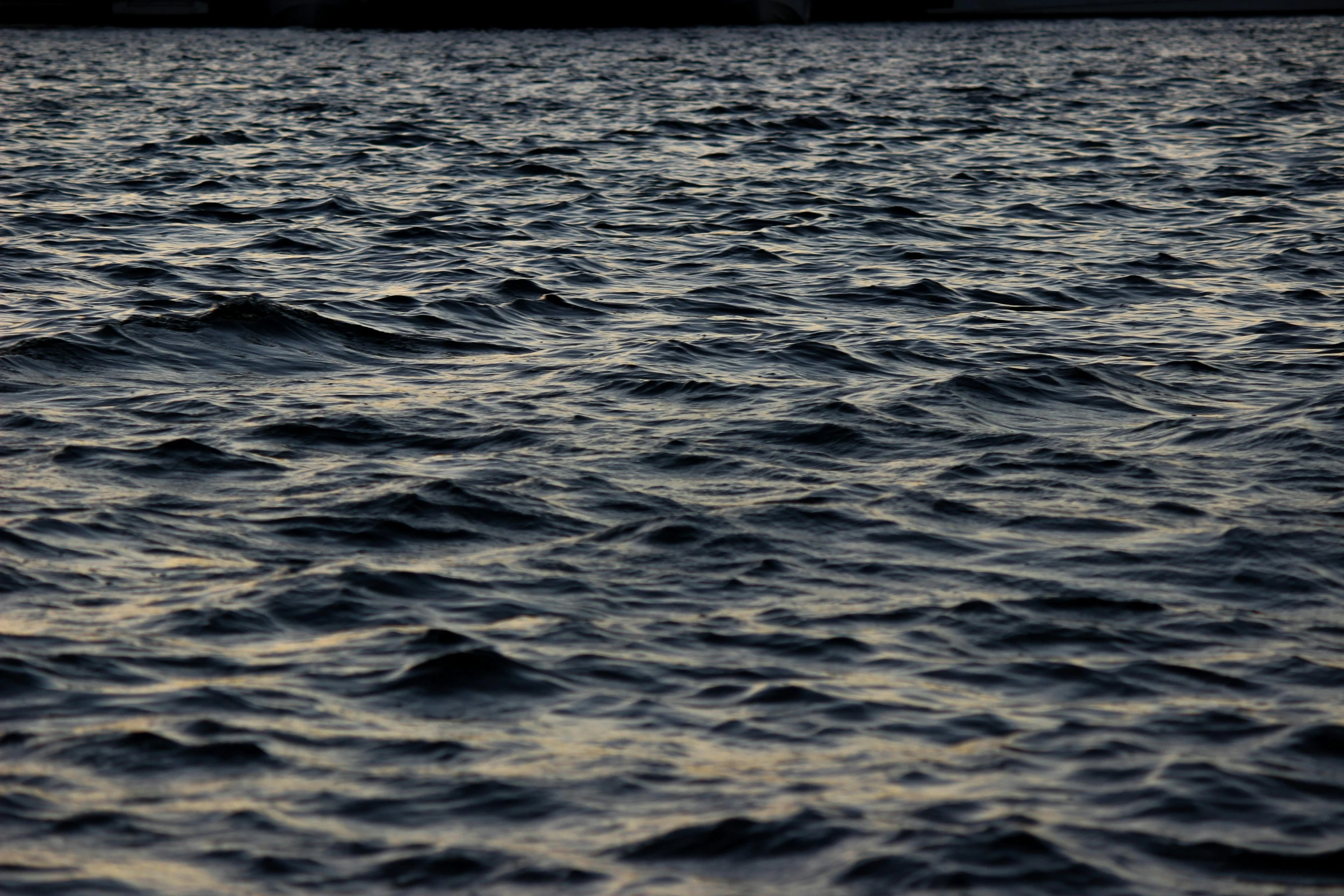 a water scene with some ships in the background