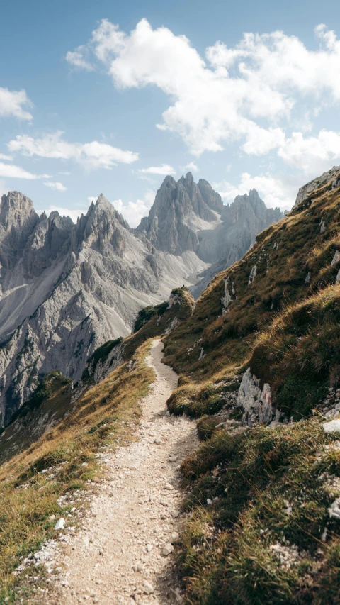 a trail meanders up the side of a mountain