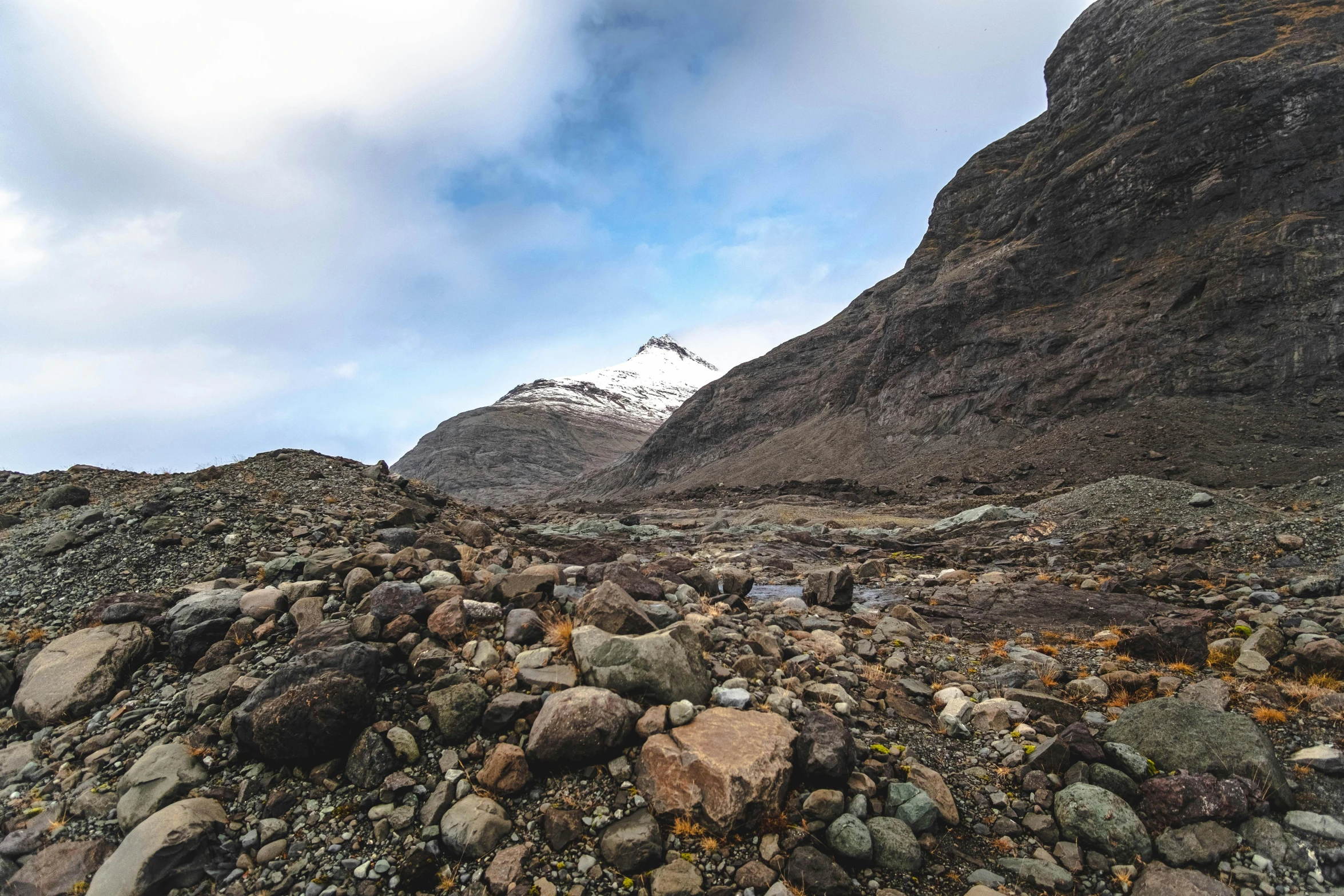 a rocky trail near the mountains, with a large amount of stones