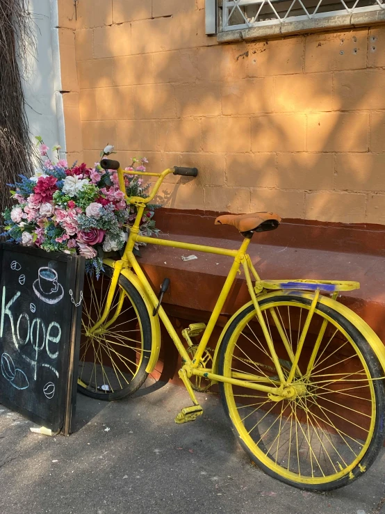 a bike  to a wooden box with flowers