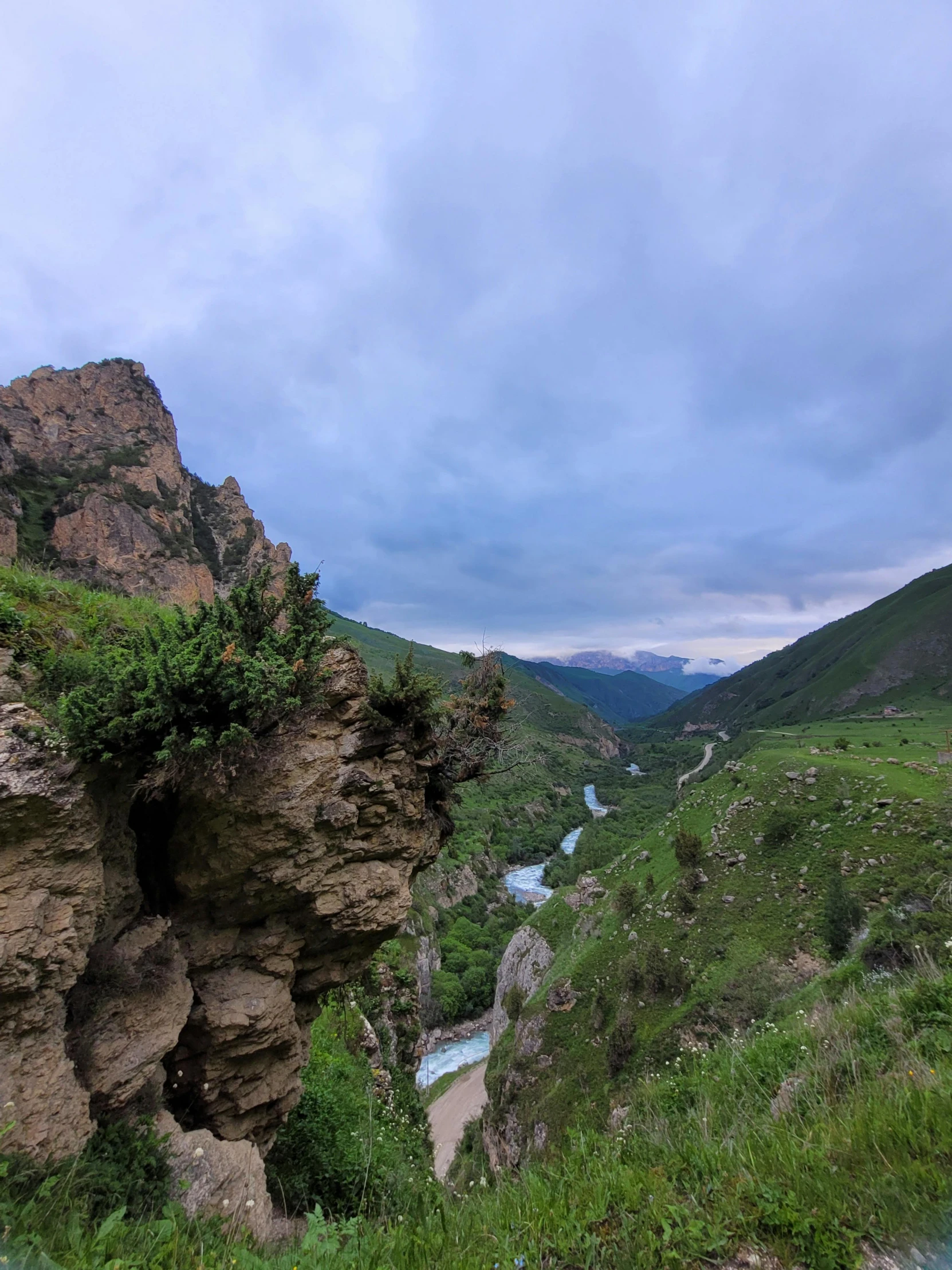 a rocky outcropping with a stream running between two mountains