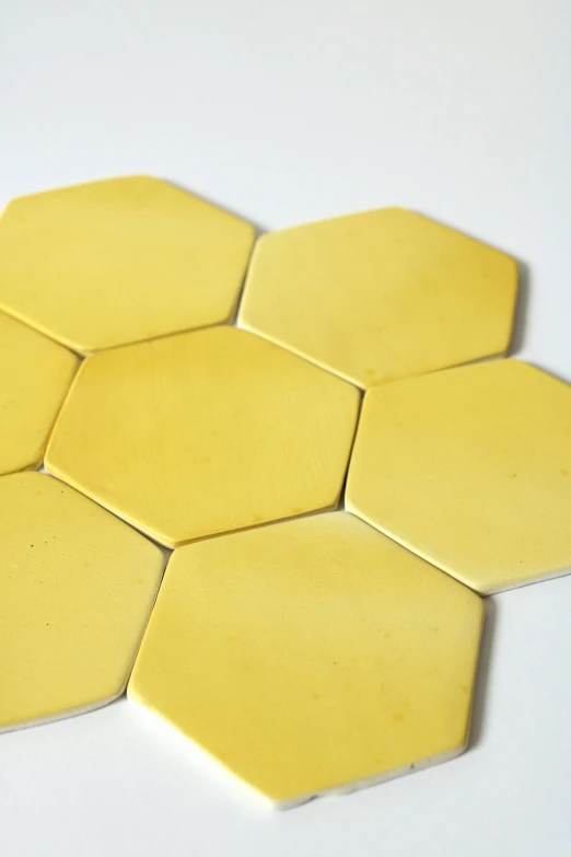 small yellow hexagonal tiles laid out on the table