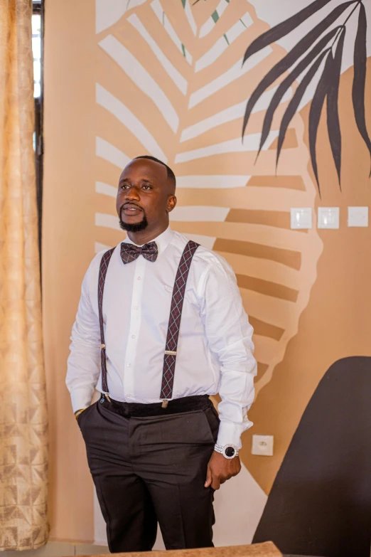 a man with a white shirt and brown bow tie