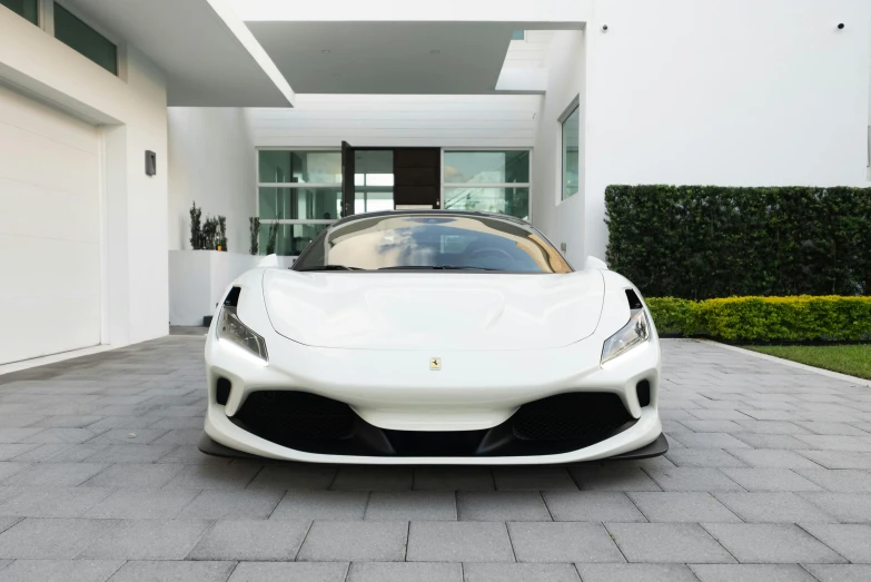 a white car sitting in front of a building