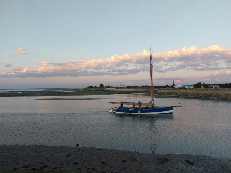 a blue boat floating on top of a lake