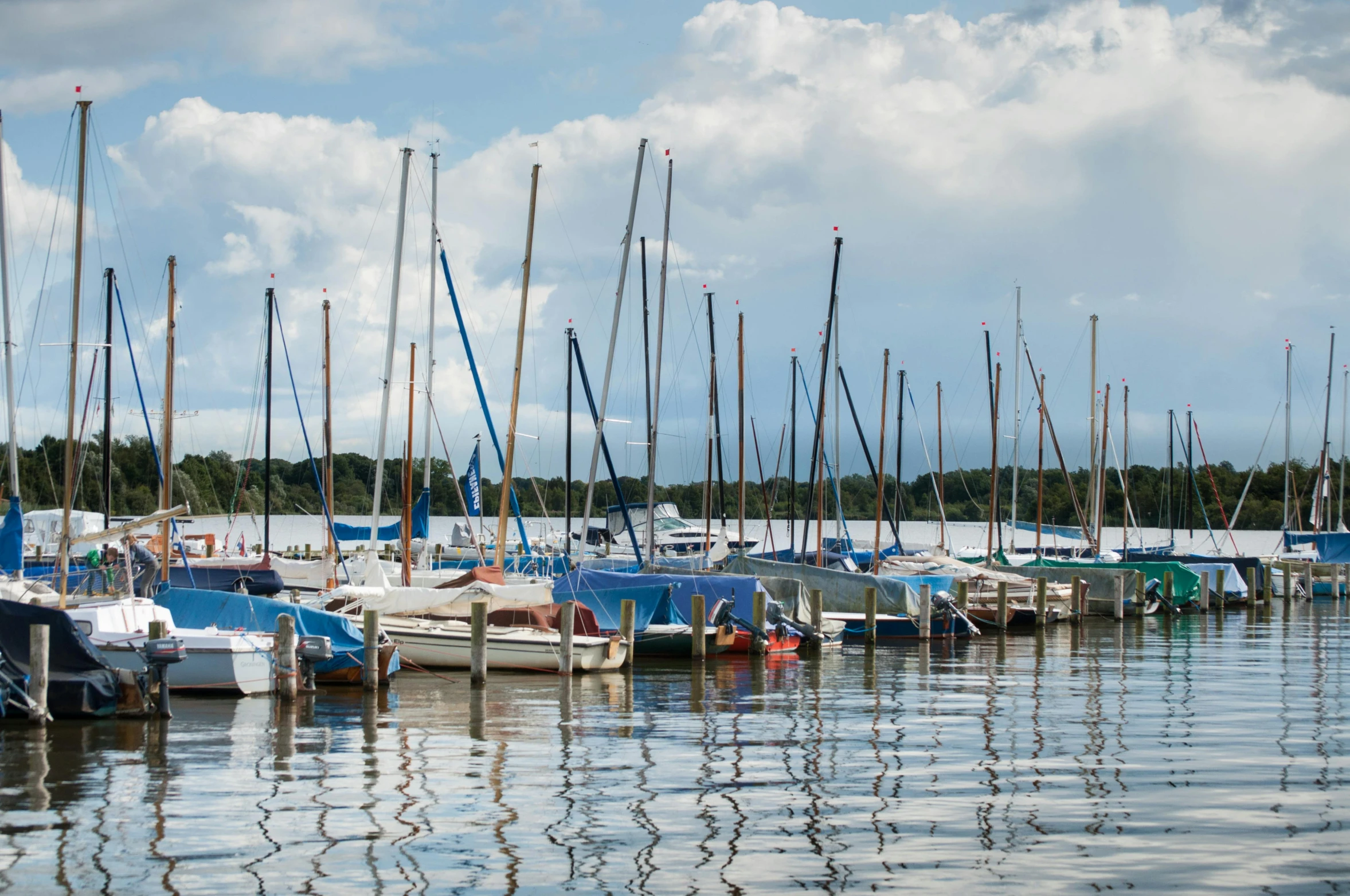 boats sitting at the shore with one person out on the water