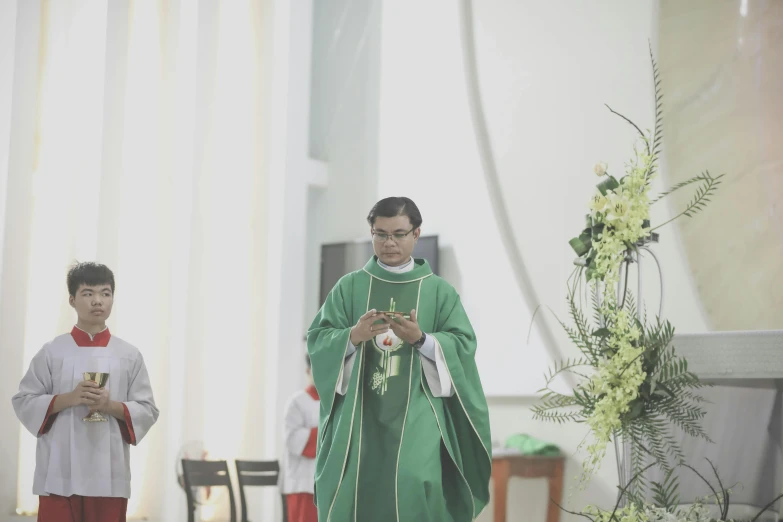 two men in green robes at a church