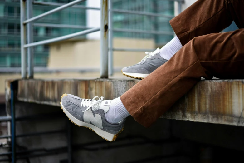 the man is sitting on a metal railing