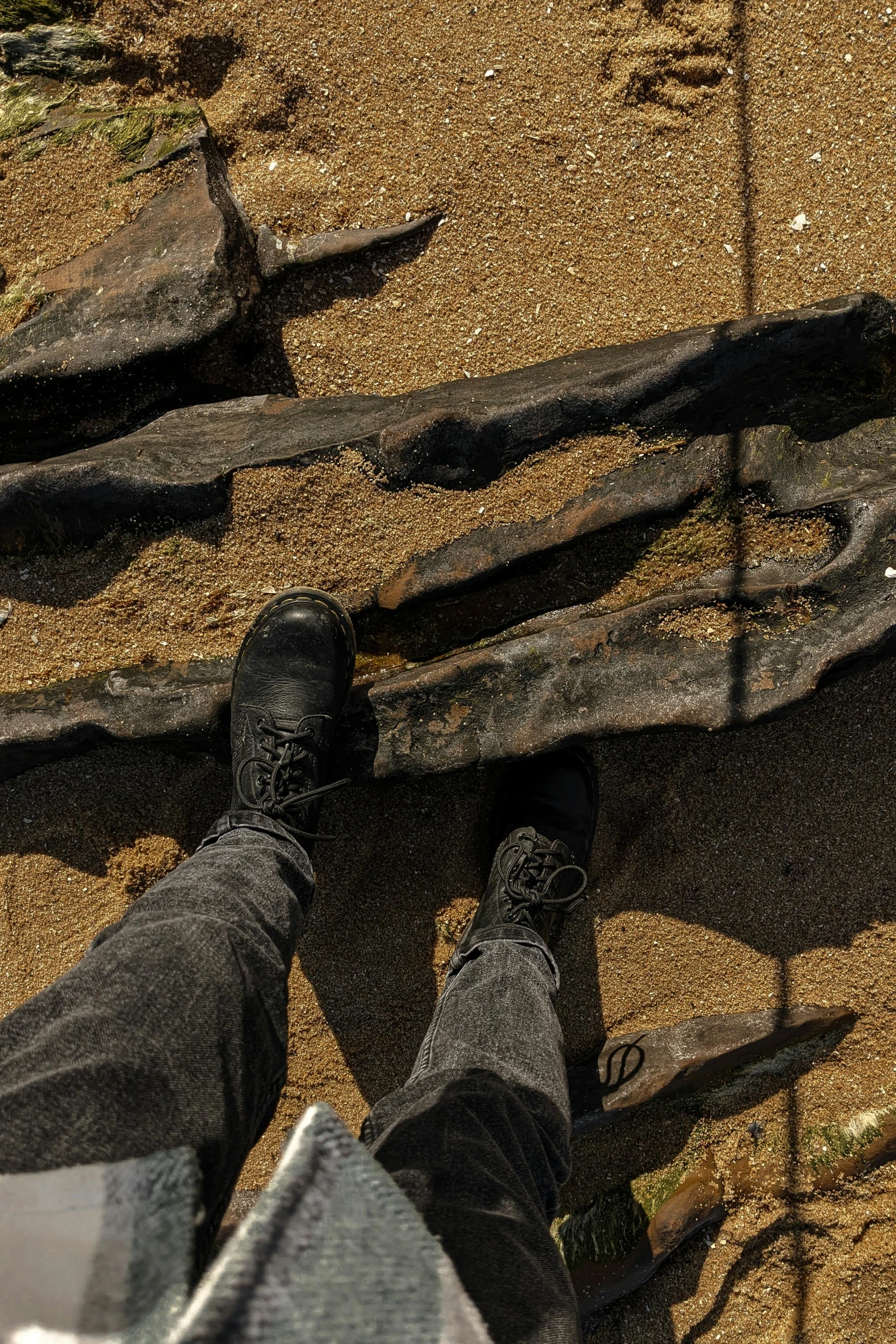 a person standing on a path surrounded by trees and rocks