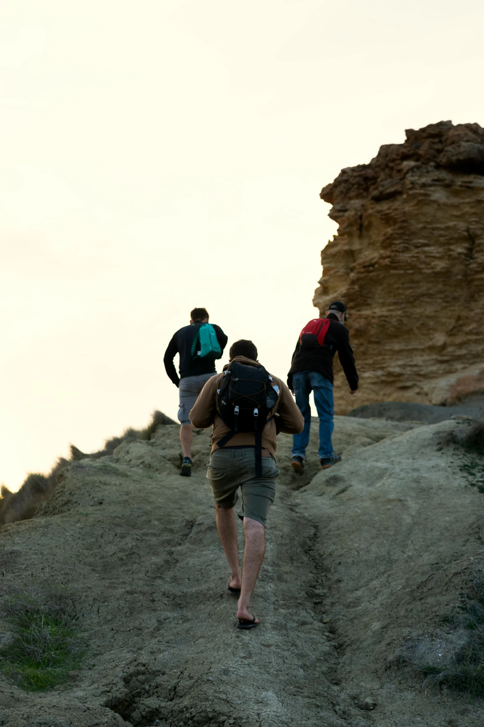 a group of people hiking up a hill