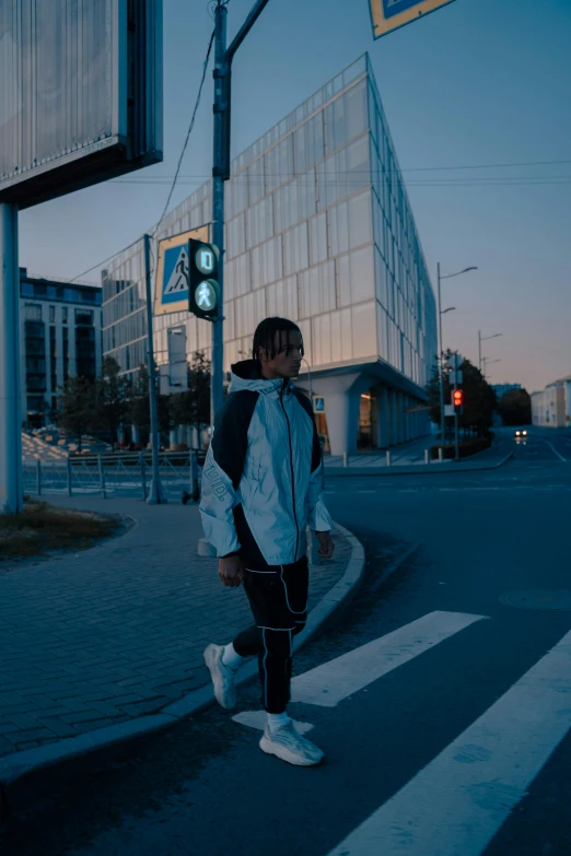 a person crossing the street at night time