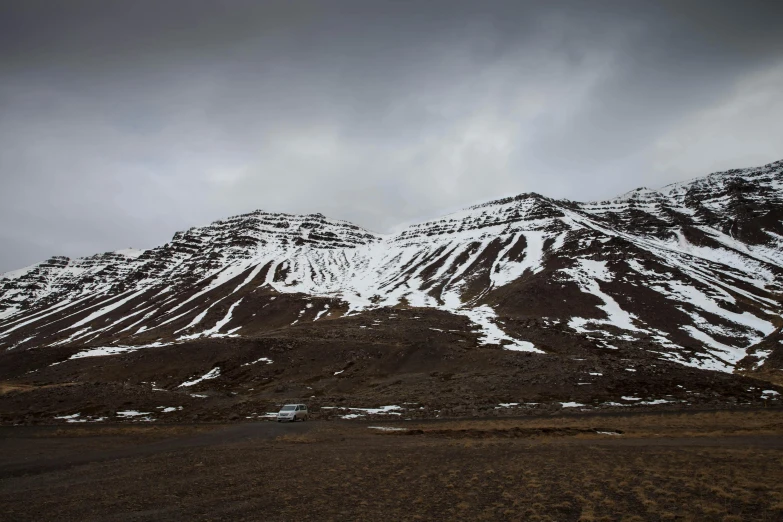 a mountain covered in snow with a sky background