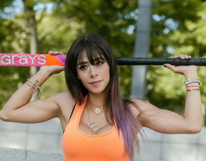 a woman is holding on to a baseball bat