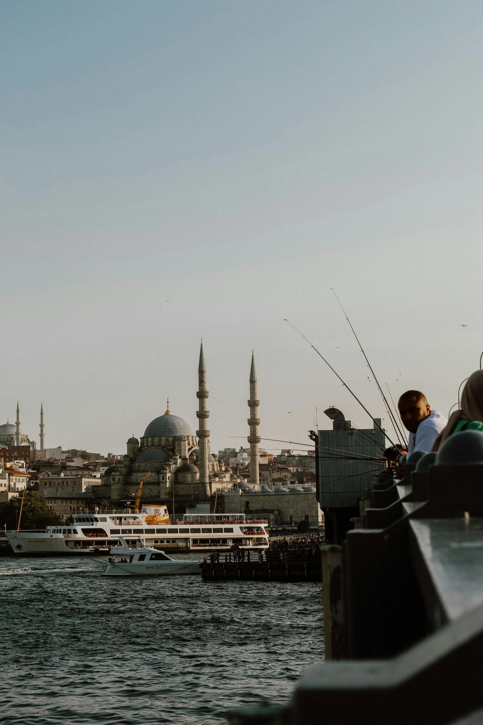 people fishing in the sea from a dock