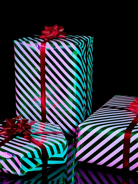 three gift boxes with red bows on each one