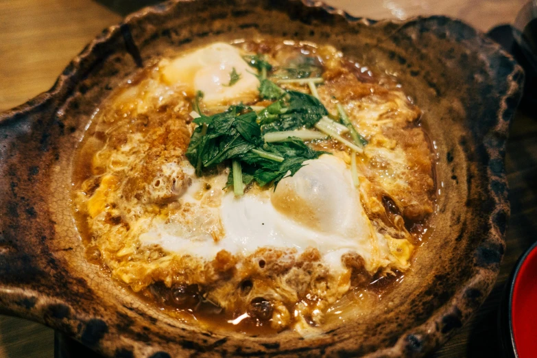 a large bowl filled with food sitting on a table