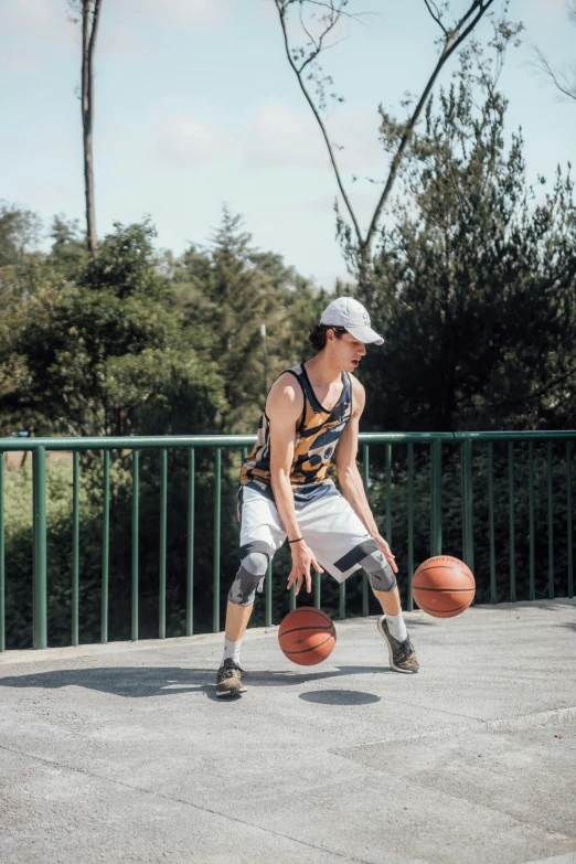 a man standing next to a basketball in his hand