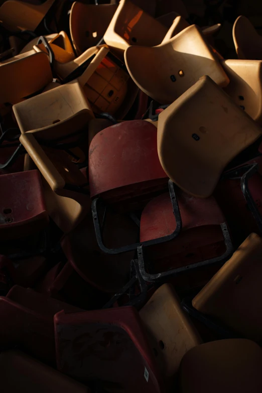 a bunch of old wooden chairs sitting on a floor