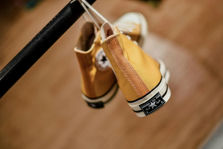 there is a pair of yellow shoes on a rail