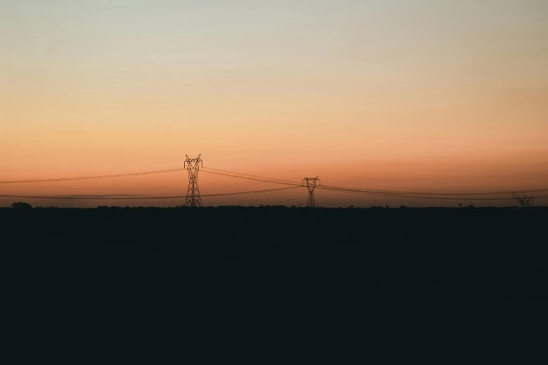 a very long power line with some clouds in the background