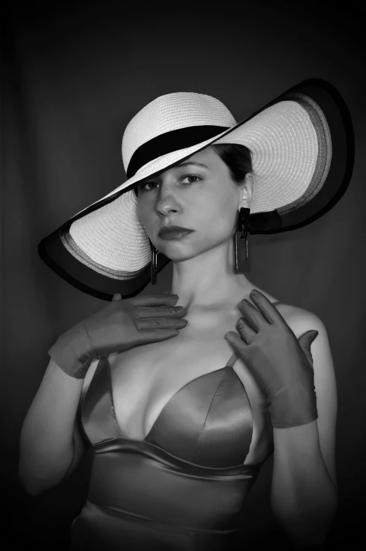 a woman in a bikini and hat poses for the camera