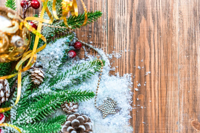 christmas decorations on a wooden table with pine cones and ribbons