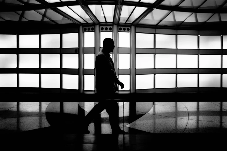 a person walks through an airport carrying an umbrella