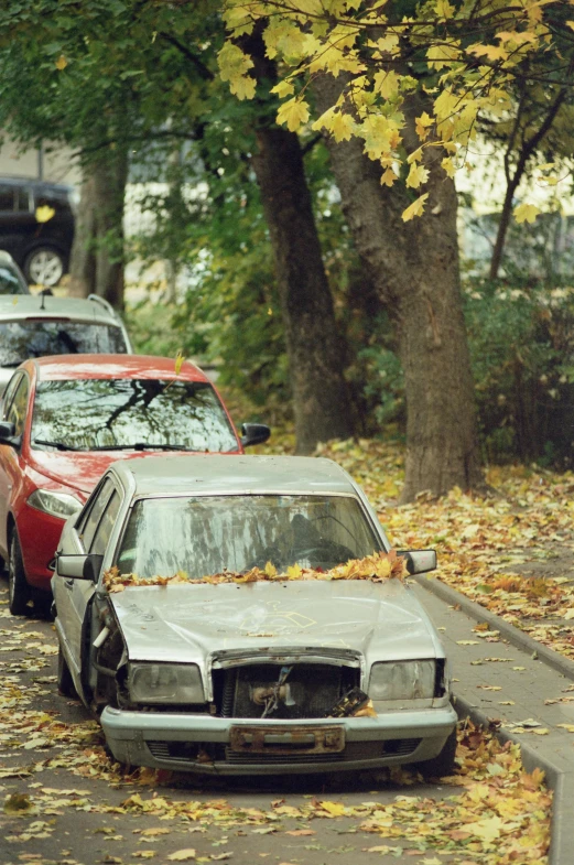 a burnt out car and its hood blown apart