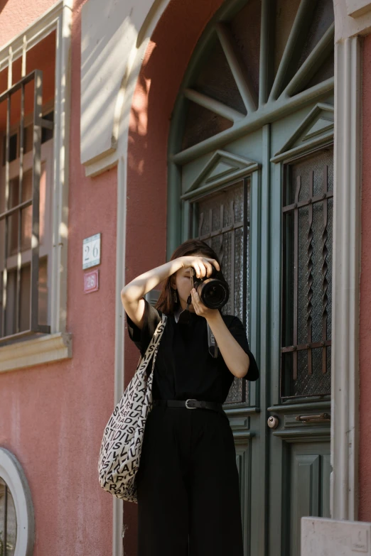 there is a woman standing outside with binoculars in her hand