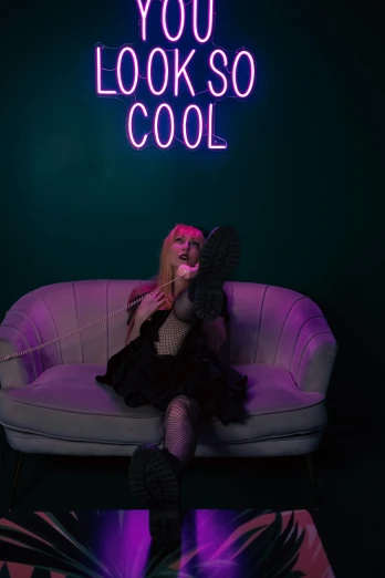 a woman sitting on a couch with the words you look so cool