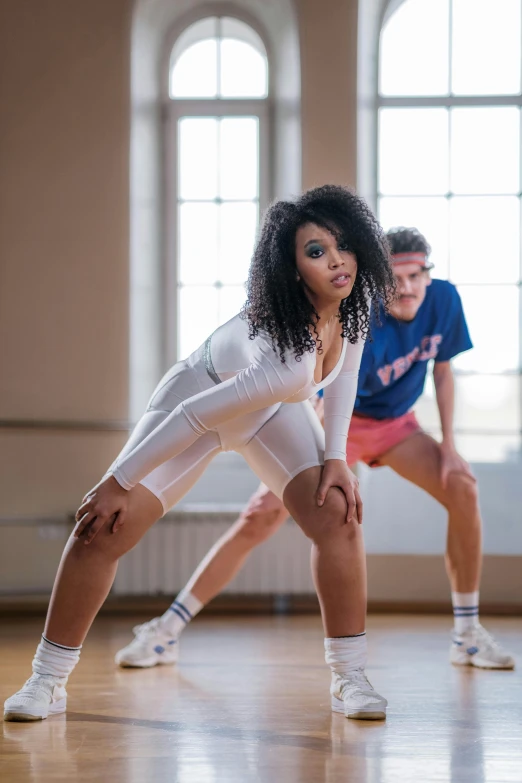 two people dressed in white are doing dance