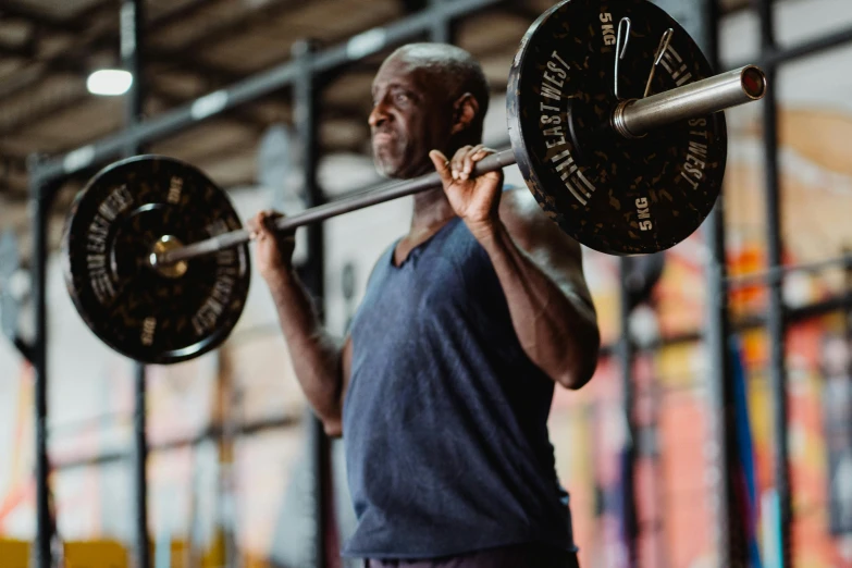 a man with  and holding a barbell