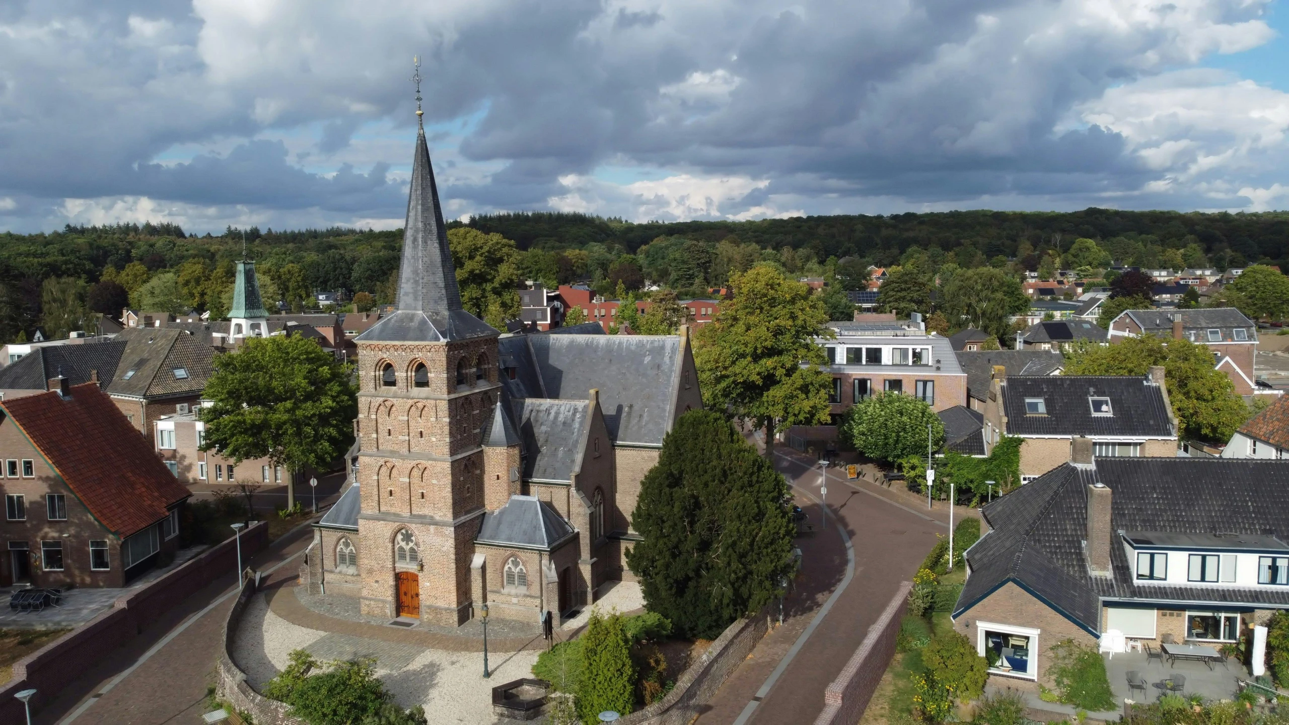 an aerial view of a small town with a clock tower