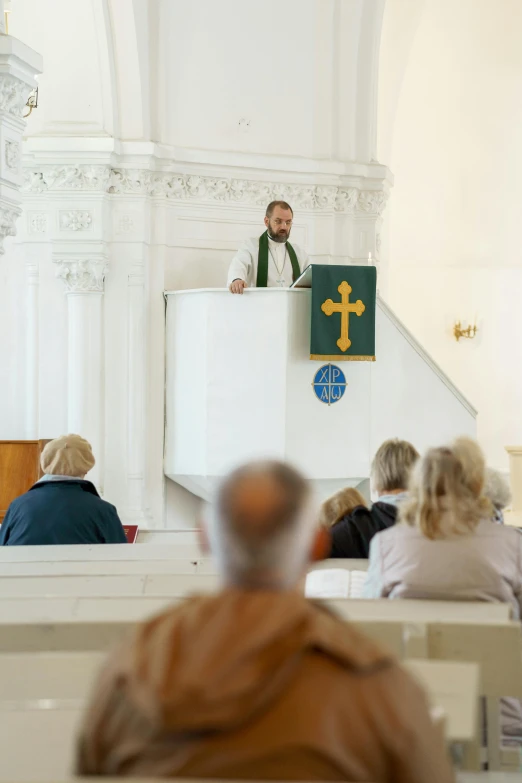 a man giving a speech in front of a crowd