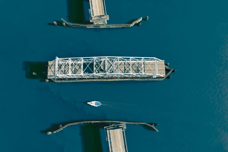 boats passing on the water next to a bridge