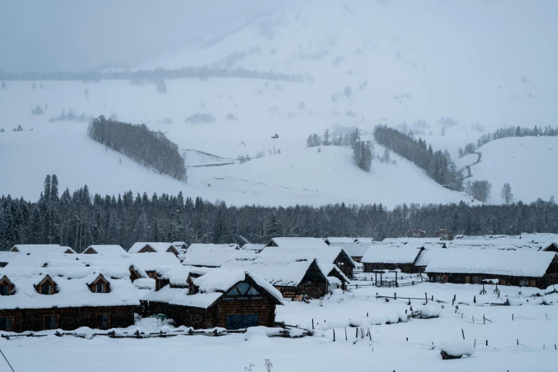 a cabin village that is very tall and covered with snow