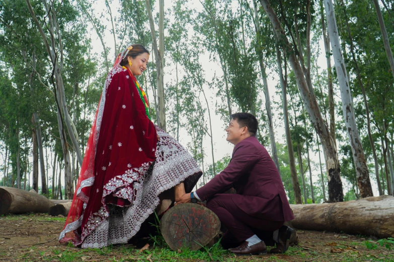 a man and a woman with a red wedding dress