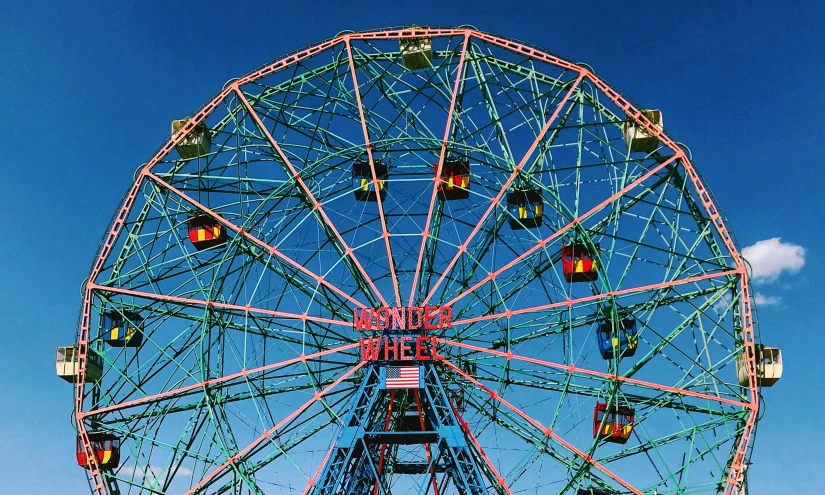 a large ferris wheel is under a blue sky