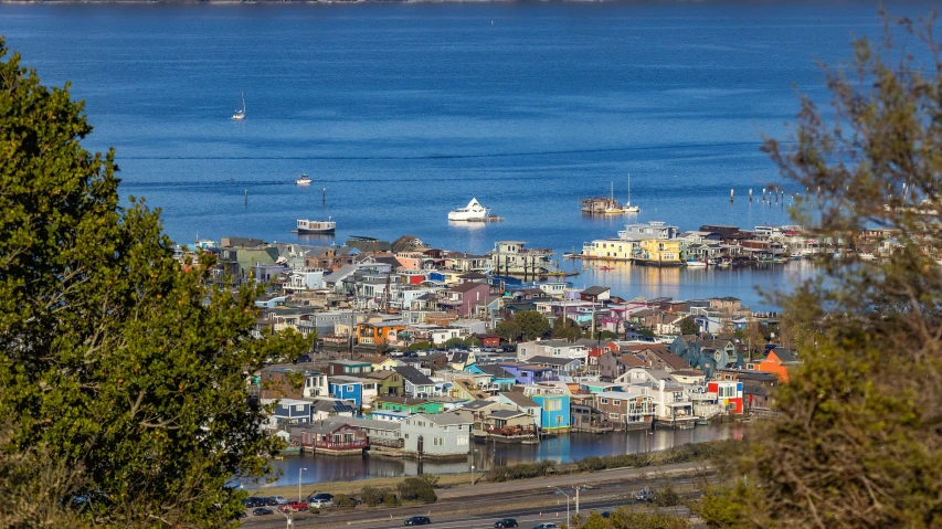 a village and harbor are on the edge of water