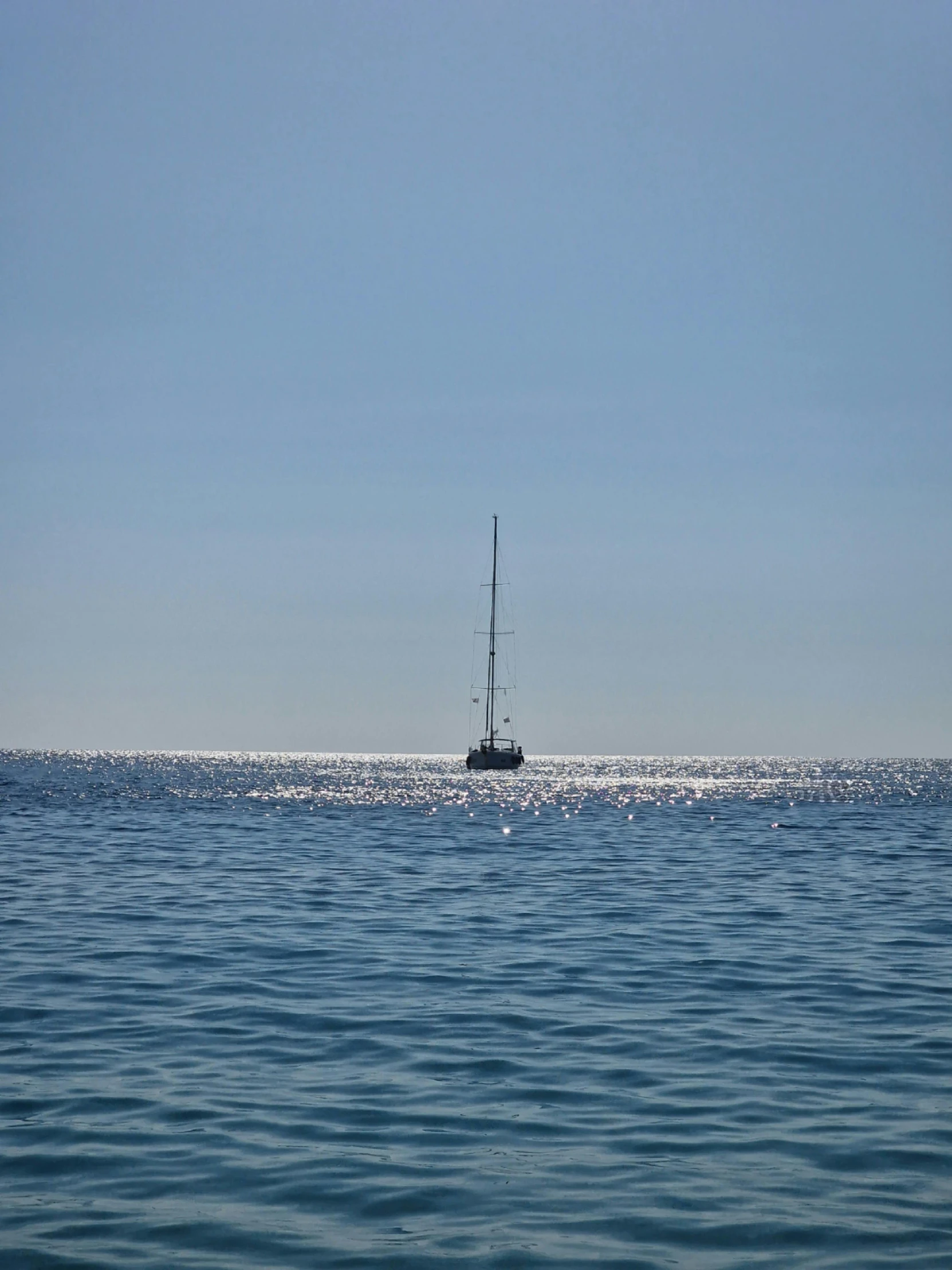 a boat out in the ocean during the day