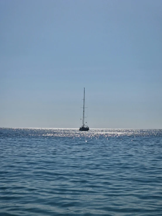 a boat out in the ocean during the day