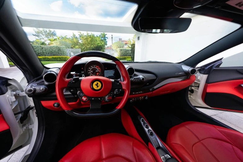 a ferrari car interior in a modern red and black hue