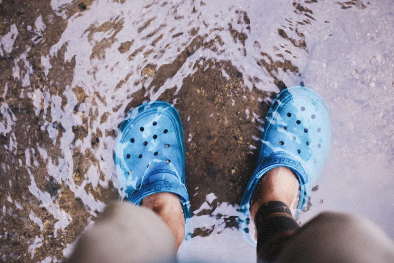 a view from the ground of someone wearing blue shoes