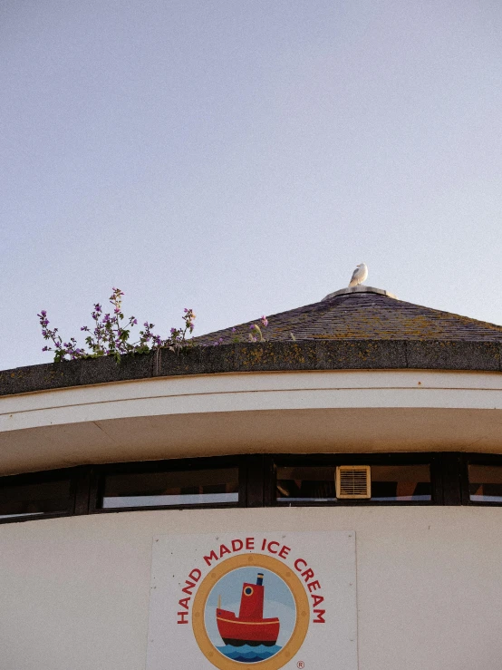 the logo and emblem on the side of a building